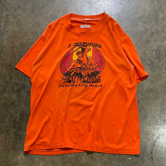 Orange "I survived the sui-slide" PCB tee